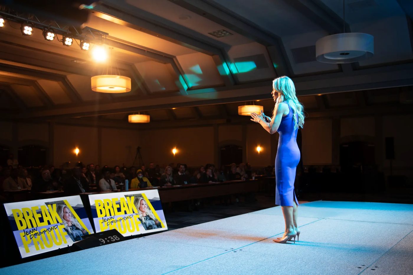 Jenn Drummond on a conference stage in front of a large audience